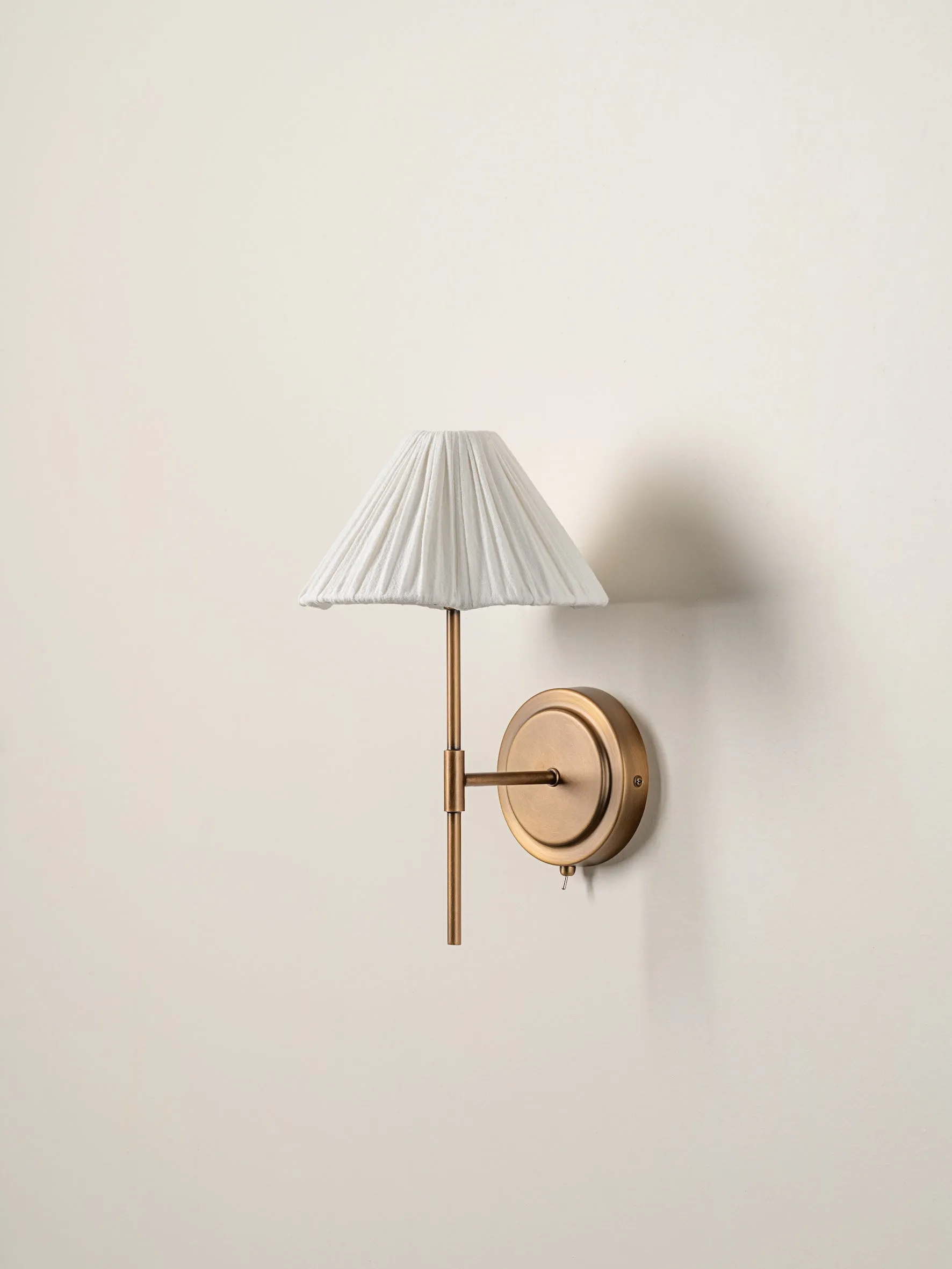 Lindi - aged brass and linen scalloped wall light